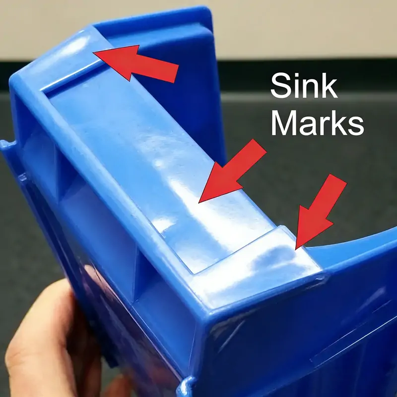 What causes shrinkage in injection molding